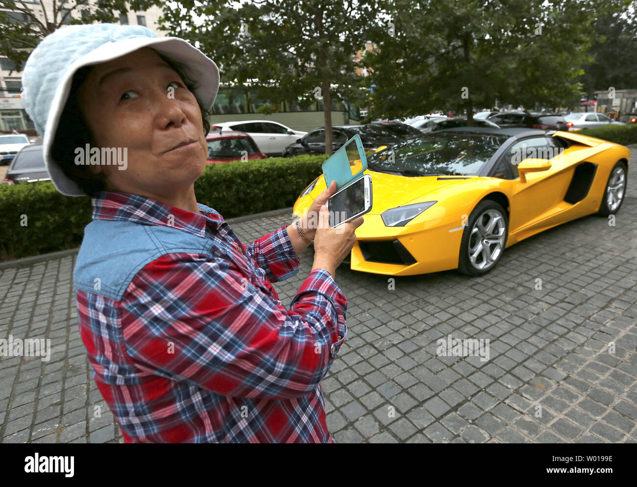 A new Lamborghini Aventador is delivered to a showroom in downtown Beijing  on October 10, 2015. China's economic growth slowdown has put the brakes on  the world's largest auto market, especially hitting