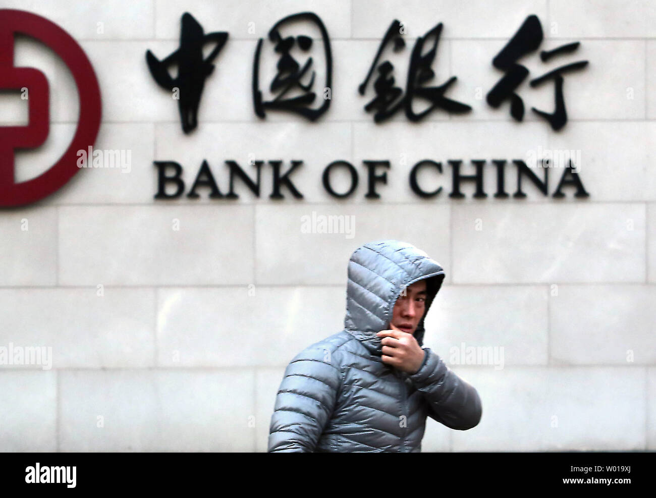 Chinese visit a Bank of China branch in downtown Beijing on January 5, 2016.  China's major stock exchanges  tanked on the first trading day of the year on Monday, triggering a 'circuit-breaker' that stopped equities trade nation-wide.  China struggled to shore up shaky sentiment a day after its stock indexes and yuan currency tumbled, rattling markets worldwide.     Photo by Stephen Shaver/UPI Stock Photo