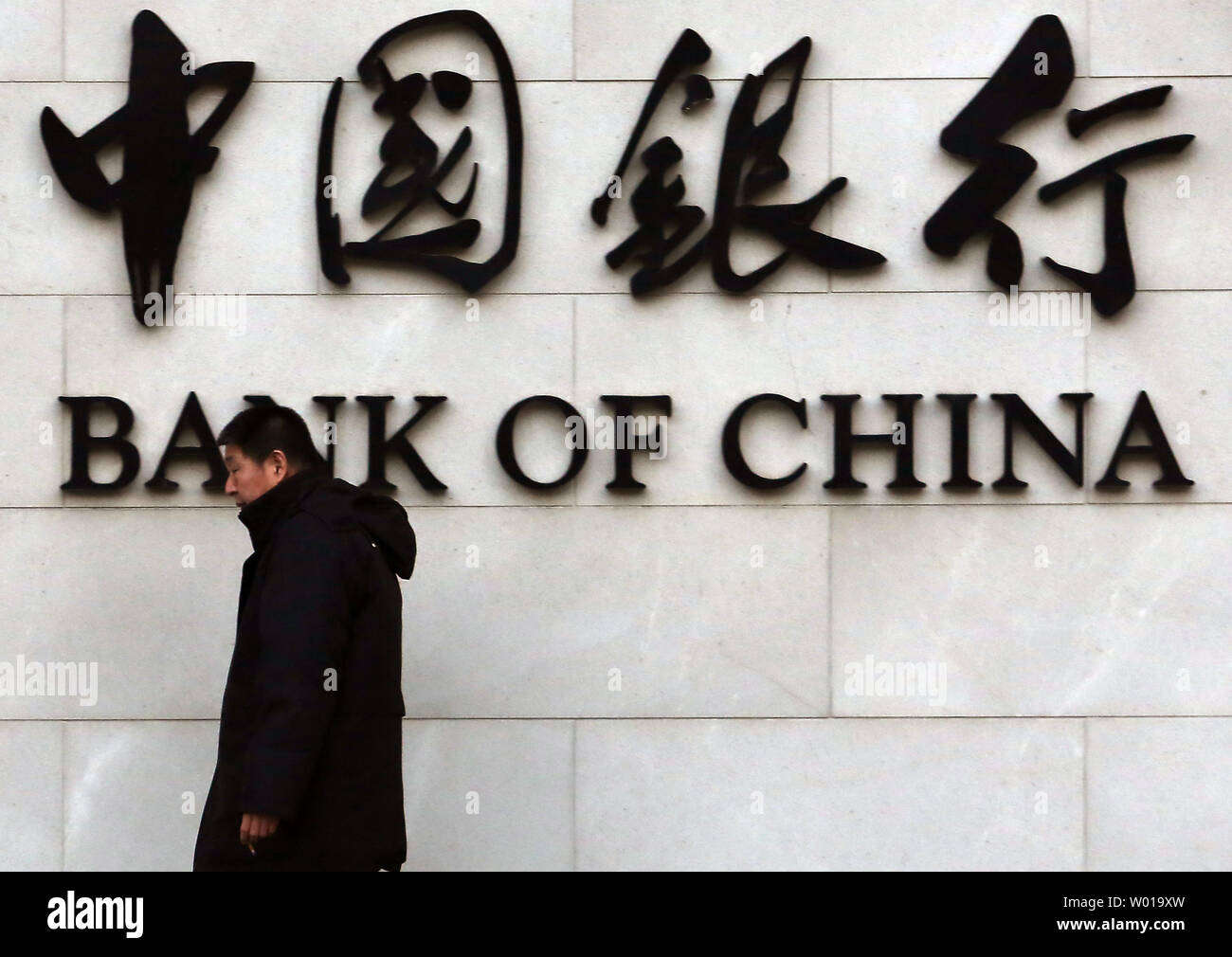 Chinese visit a Bank of China branch in downtown Beijing on January 5, 2016.  China's major stock exchanges  tanked on the first trading day of the year on Monday, triggering a 'circuit-breaker' that stopped equities trade nation-wide.  China struggled to shore up shaky sentiment a day after its stock indexes and yuan currency tumbled, rattling markets worldwide.     Photo by Stephen Shaver/UPI Stock Photo