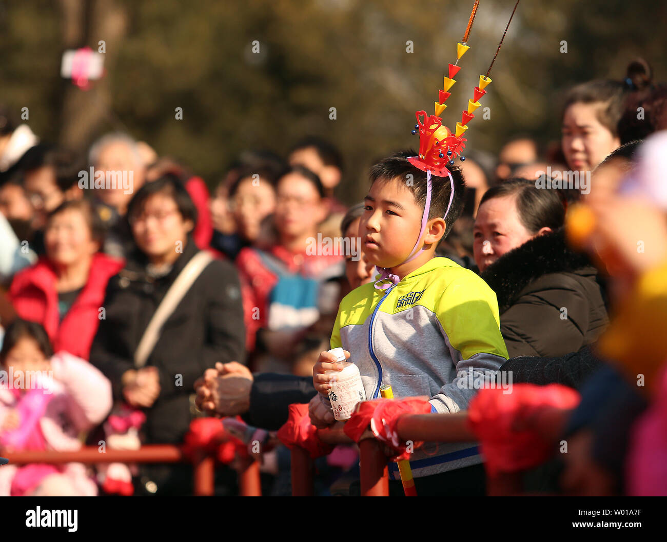 Chinese watch performers at a Spring Festival fair in Beijing on February 10, 2016.  About a fourth of the planet's population will be on the move as China celebrates the Year of the Fire Monkey this week.  Nearly 1.4 billion Chinese will begin the largest annual migration on Earth rushing home for China's most important holiday.    Photo by Stephen Shaver/UPI Stock Photo