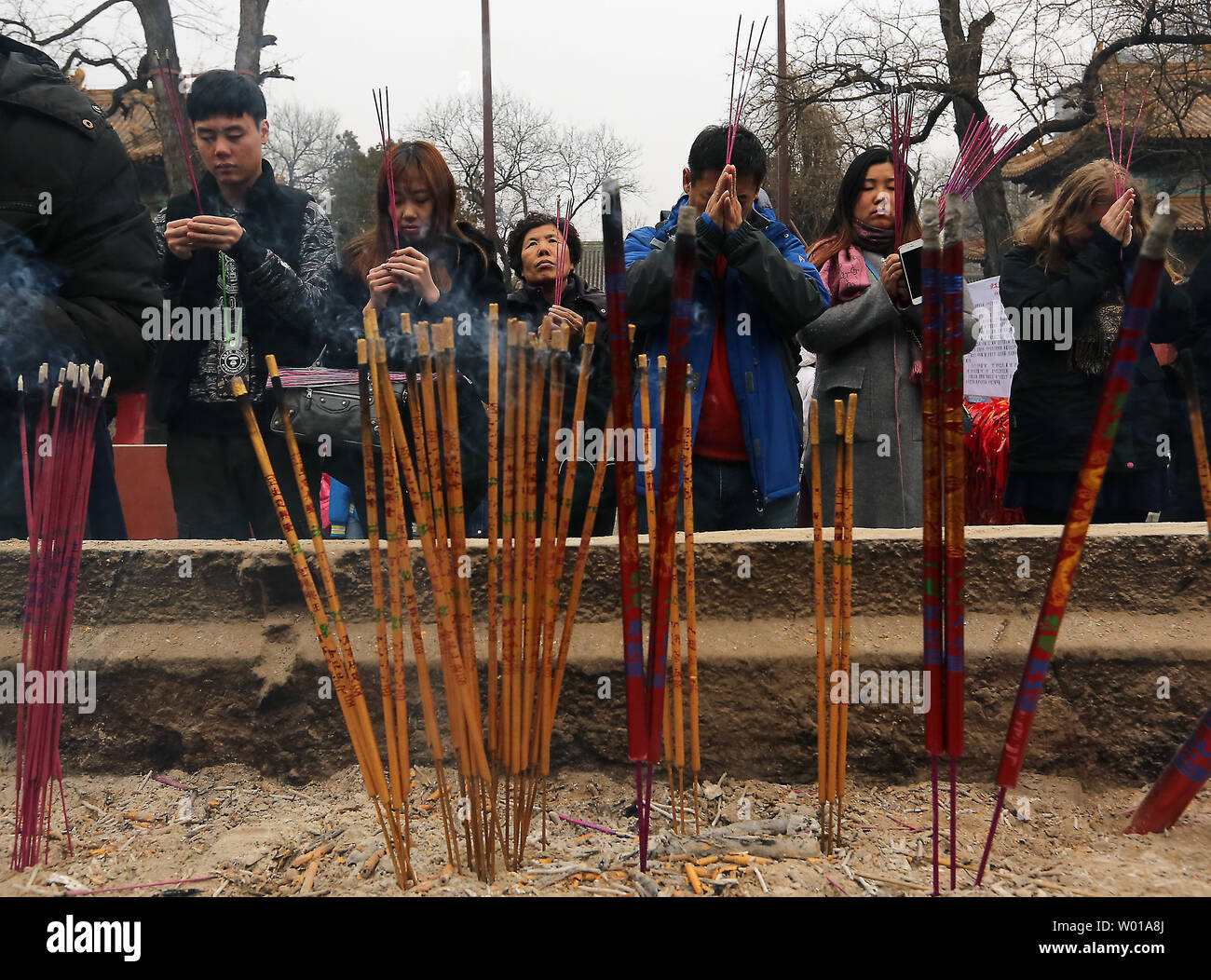 Chinese pray at a temple during the annual Spring Festival in Beijing on February 12, 2016.  This year's holiday was notably subdued, with vastly less fireworks and outdoor performances, due to China's economic slowdown and pollution concerns.    Photo by Stephen Shaver/UPI Stock Photo