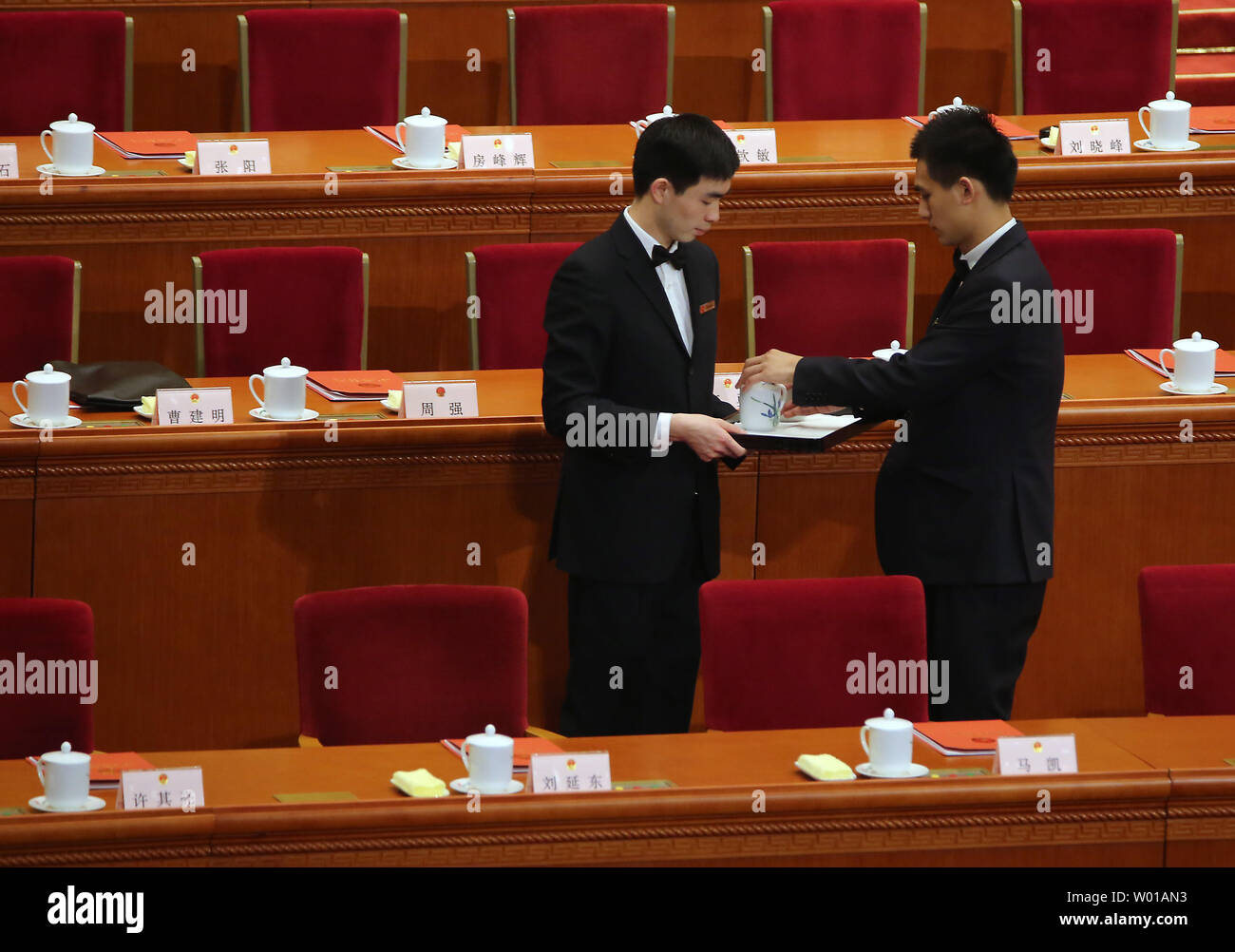 Chinese attendants deliver tea for China's top leaders prior to the closing session of the National People's Congress in the Great Hall of the People in Beijing on March 16, 2016.  China's Communist-controlled 'rubber stamp' legislature approved an economic roadmap for the next five years and a charity law among a series of measures to address the country's growth.         Photo by Stephen Shaver/UPI Stock Photo