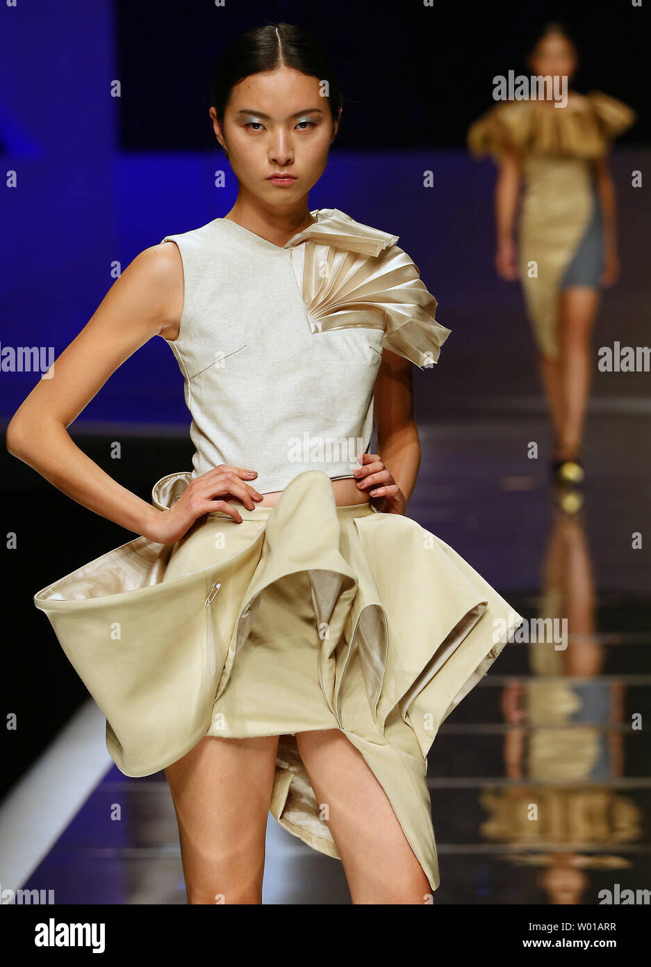 Chinese models showcase fashion designs during the opening ceremony fashion show 'China International Young Fashion Designers Contest Final' at the start of China's fashion week in Beijing on March 25, 2016.  Chinese fashion designers are becoming an international force with both European and American fashion houses looking at the new, fresh Chinese clothing-minds as potential partners in future clothing brands.      Photo by Stephen Shaver/UPI Stock Photo