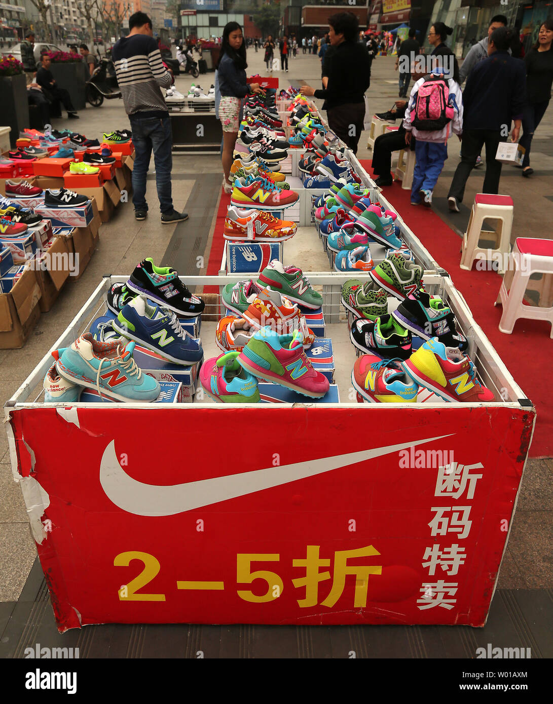 Knock-off Nike and New Balance athletic shoes are sold outside a shopping  mall in Beijing on April 15, 2016. China's government is still wrestling  with the rampant knock-off and counterfeit products manufactured