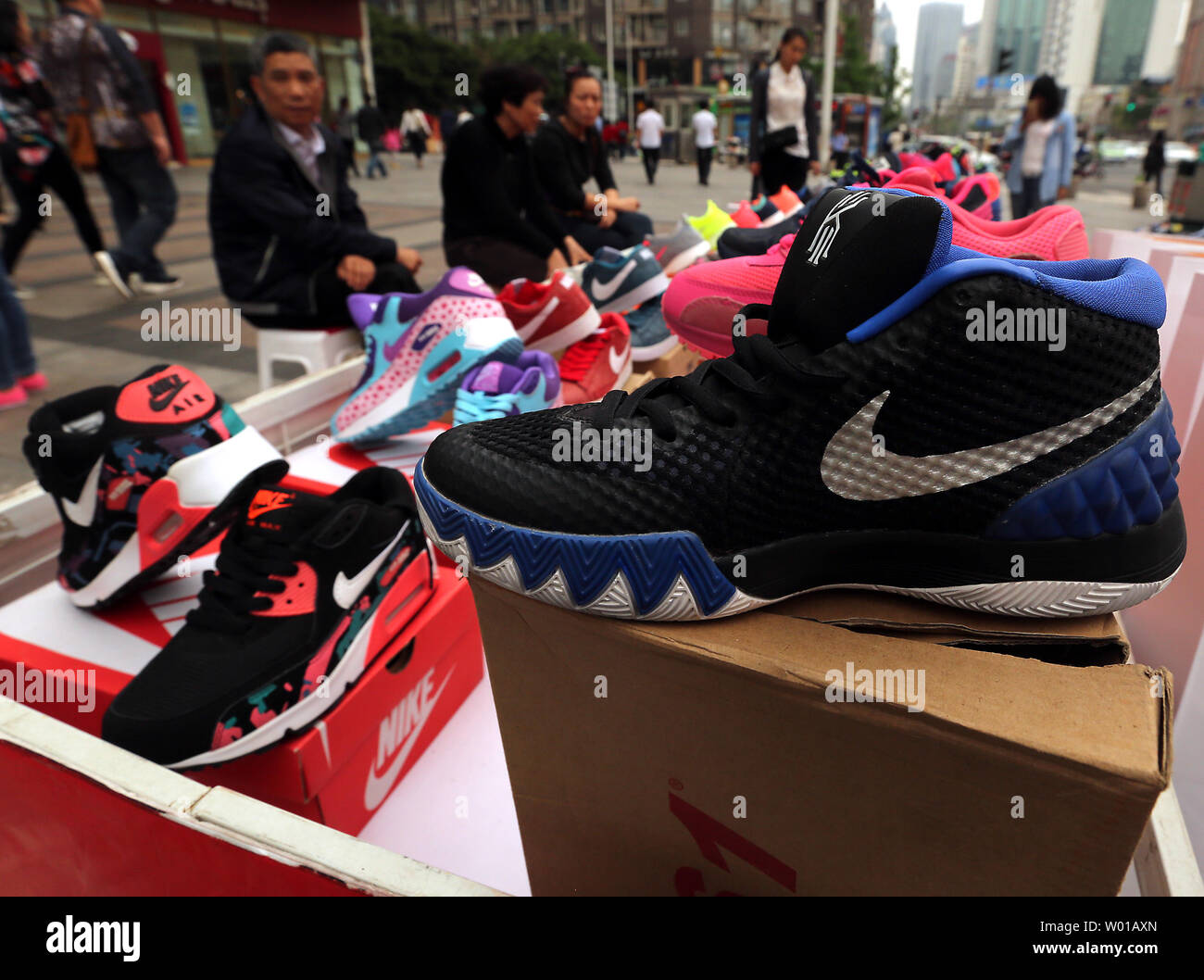 Knock-off Nike and New Balance athletic shoes are sold outside a shopping  mall in Beijing on April 15, 2016. China's government is still wrestling  with the rampant knock-off and counterfeit products manufactured