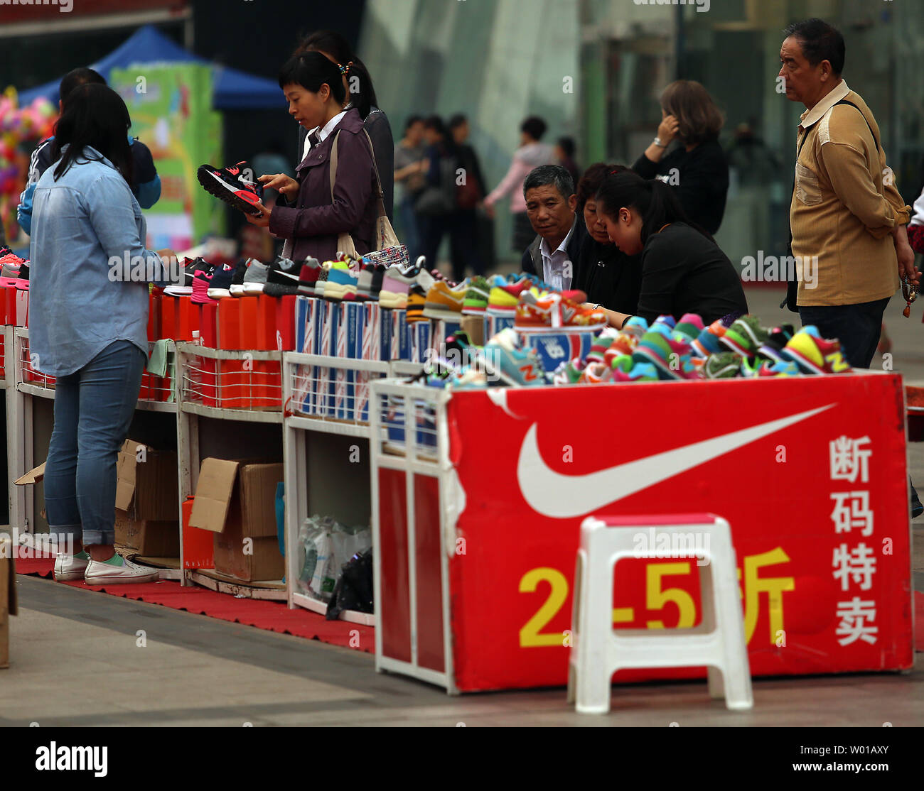 Knock-off Nike and New Balance athletic shoes are sold outside a shopping mall in Beijing on April 15, 2016.  China's government is still wrestling with the rampant knock-off and counterfeit products manufactured in China, robbing many foreign brands of both profits and trademark protection.      Photo by Stephen Shaver/UPI Stock Photo