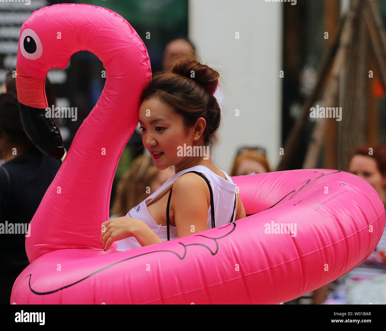 A Chinese Woman Wears An Inflatable Flamingo While Advertising A Bar S Weekend Pool And Foam Party In Beijing On August 13 2016 Being Landlocked Beijing S Robust And Competitive Bar Scene Frequently Hosts