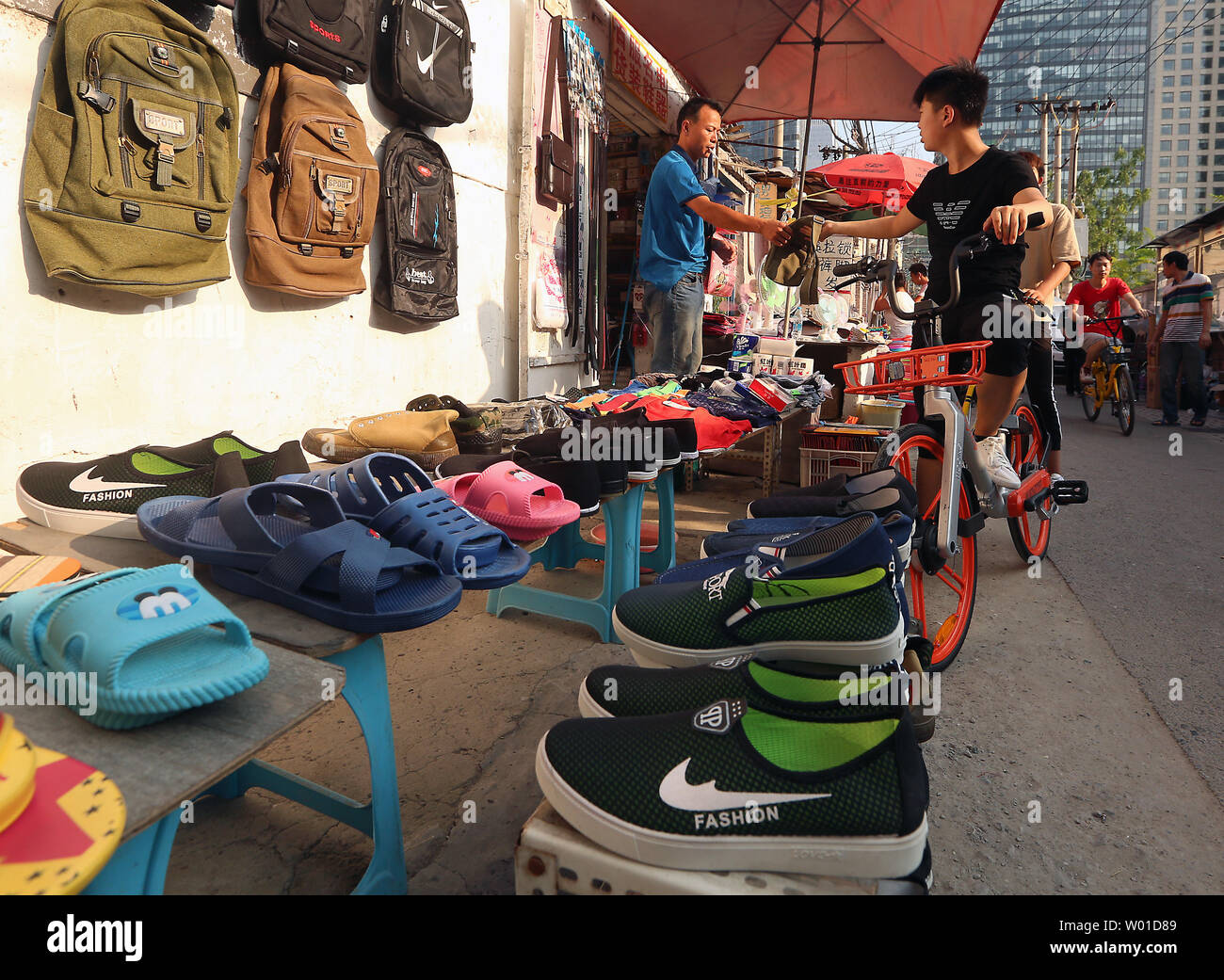 Fake Nike shoes and backpacks are sold in an alley in downtown Beijing on  July 30, 2017. International Property Rights (IPR) remain a thorny issue  with the U.S. government and China due