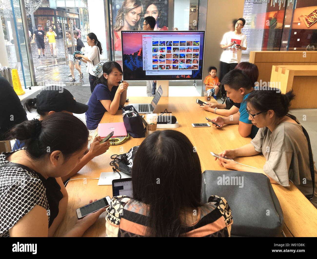 Chinese use their iPhones while attending a free workshop on using Apple software at Beijing's flagship Apple store on August 2, 2017.  Apple boss Tim Cook has defended his company's decision to comply with the Chinese government's demand it remove VPN software from the Chinese App Store.  Moves by Apple and Amazon to stop consumers from using censorship-skirting apps in China have renewed questions about the extent U.S. companies are willing to work with Chinese authorities in the vast but tightly controlled Chinese technology market.     Photo by Stephen Shaver/UPI Stock Photo