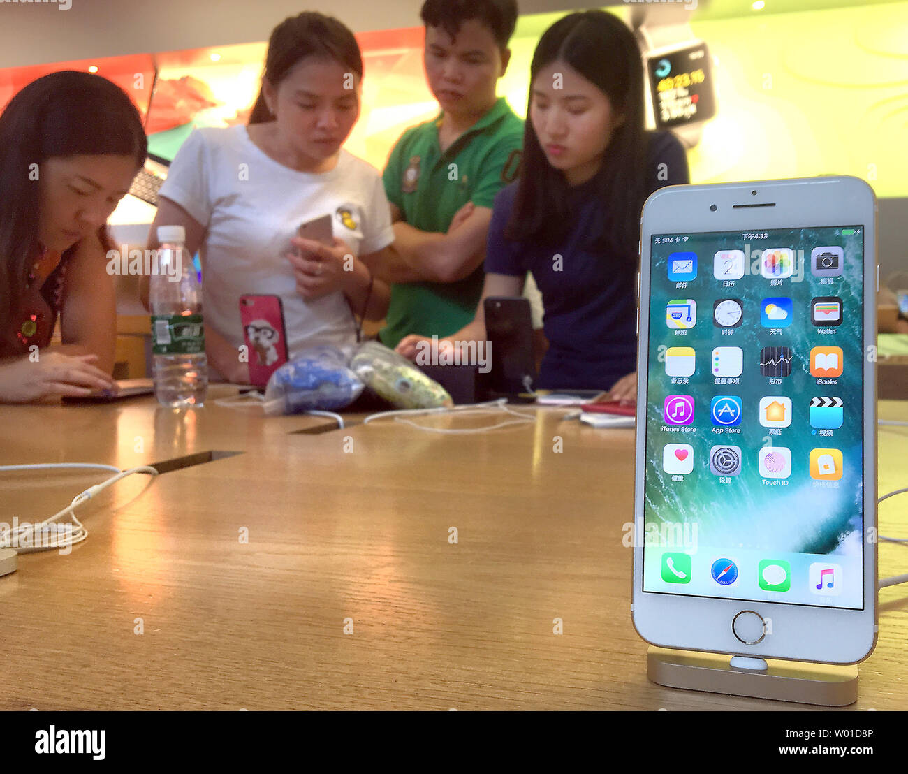 Chinese look at iPhones on display in Beijing's flagship Apple store on August 2, 2017.  Apple boss Tim Cook has defended his company's decision to comply with the Chinese government's demand it remove VPN software from the Chinese App Store.  Cook said Apple had to obey the country's laws.  Moves by Apple and Amazon to stop consumers from using censorship-skirting apps in China have renewed questions about the extent U.S. companies are willing to work with Chinese authorities in the vast but tightly controlled Chinese technology market.     Photo by Stephen Shaver/UPI Stock Photo