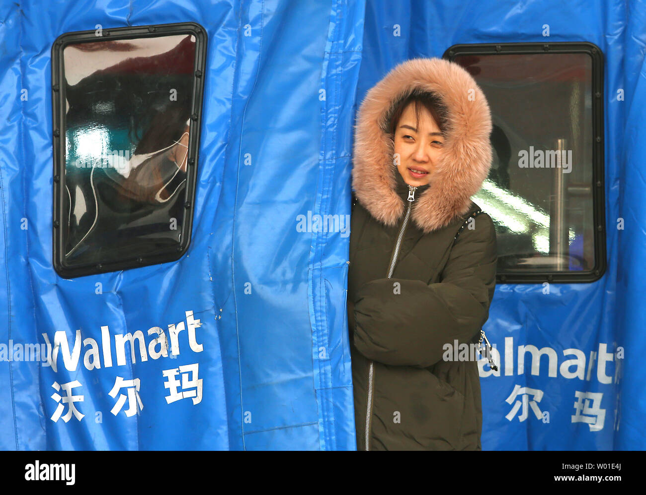 Chinese shoppers leave one of the many Walmart stores in Beijing on