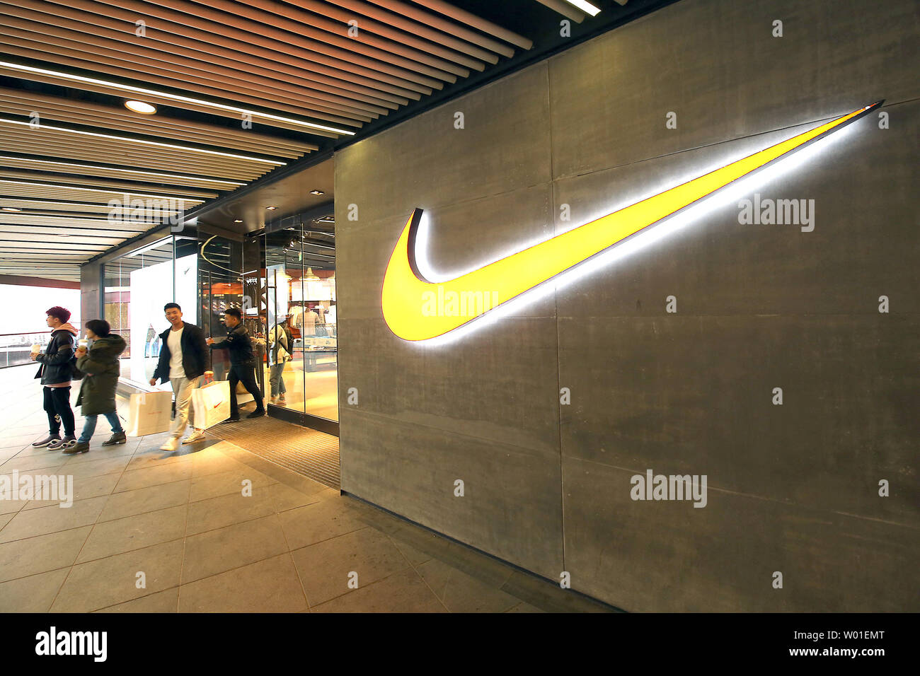 Chinese shop at a Nike store in Beijing on April 3, 2018. China says ti  will respond to any new trade tariffs by the U.S. with measures of the same  scale and