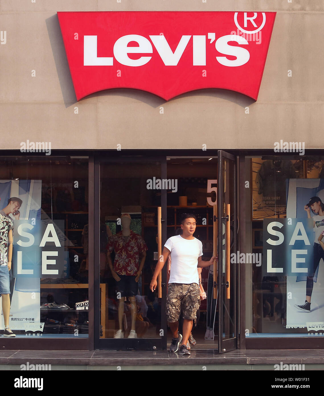 Chinese leave a famous . brand clothing store, Levi's, at a Western  shopping plaza in Beijing on June 10, 2018. China said Sunday that it would  not increase its purchases of American