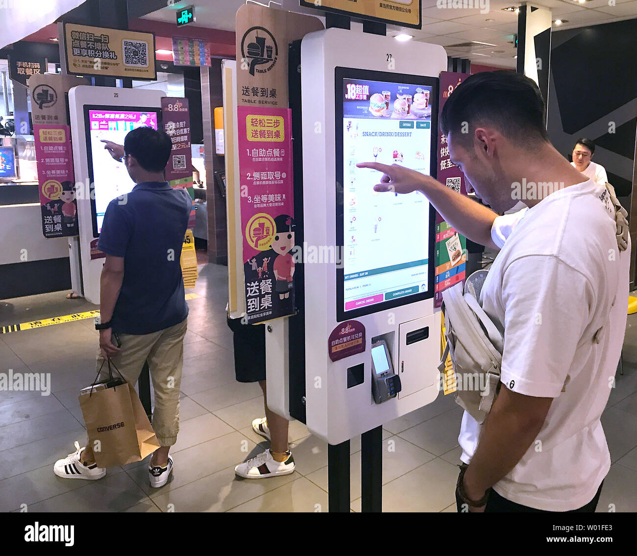 Chinese order food at automated screens at a McDonald's in Beijing on August 18, 2018.  McDonald's plans to open 2,000 additional restaurants in China, which will make China the company's second largest market after the U.S..      Photo by Stephen Shaver/UPI Stock Photo