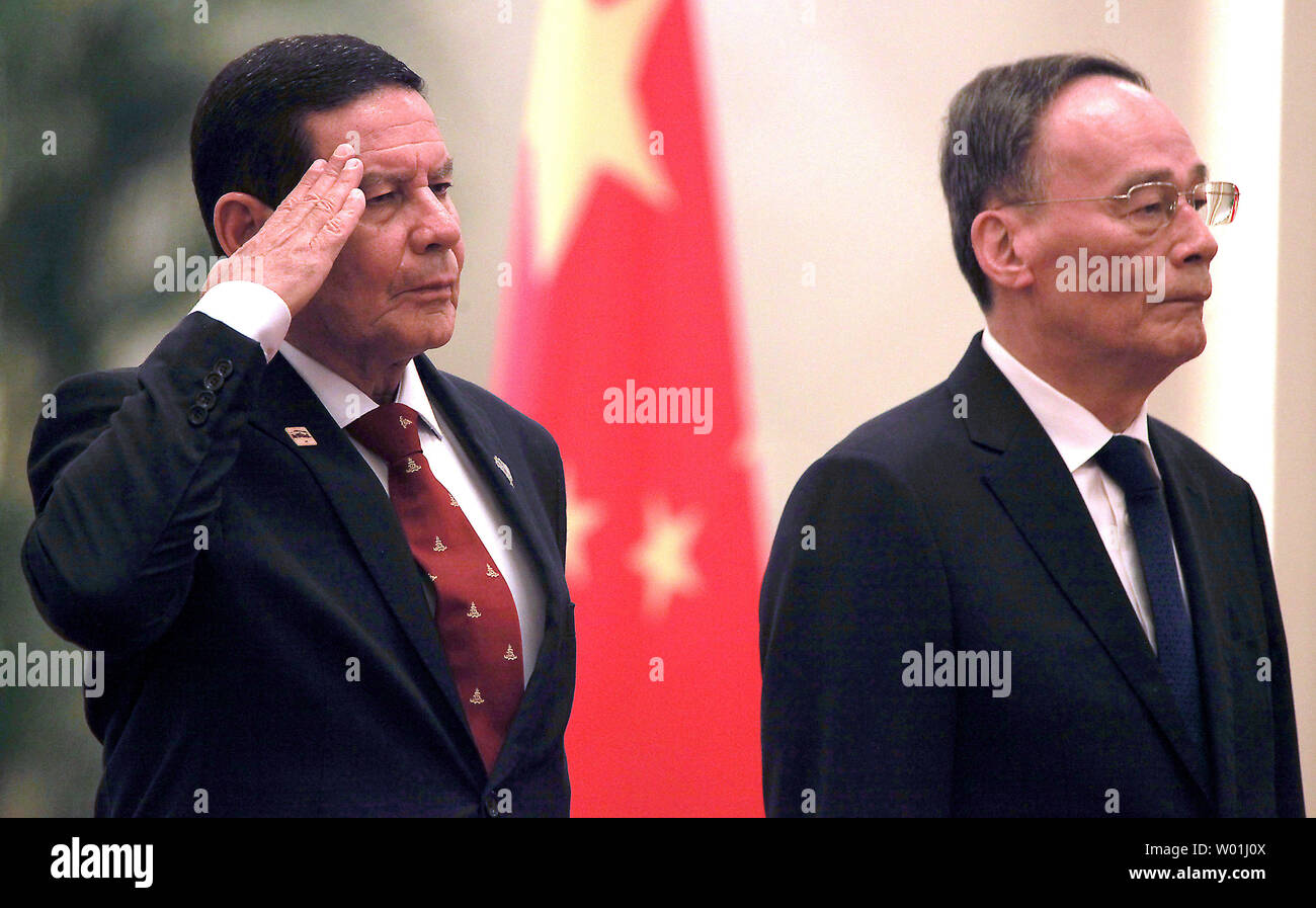 Brazilian Vice-President Hamilton Mourao (L) and Chinese Vice-President Wang Qishan listen to their respective national anthems during a welcoming ceremony in the Great Hall of the People in Beijing on May 23, 2019.  Mourao is on a five-day state visit to China's capital in hopes of patching up wounds caused by Brazilian President Jair Bolsonaro's abrasive anti-China rhetoric.      Photo by Stephen Shaver/UPI Stock Photo