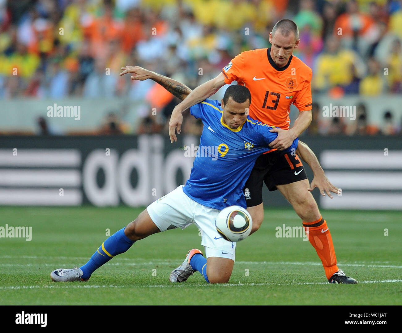 Andre Ooijer of The Netherlands and Luis Fabiano of Brazil chase the ball during the FIFA World Cup Quarter Final match at the Nelson Mandela Bay Stadium in Port Elizabeth, South Africa on July 2, 2010. The Netherlands beat Brazil 2-1. UPI/Chris Brunskill Stock Photo