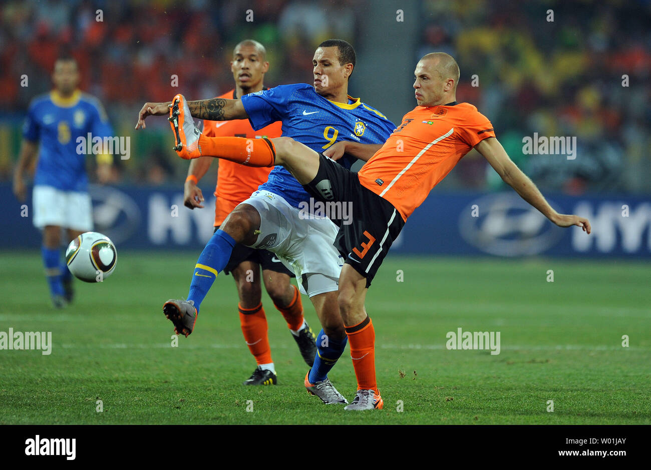 John Heitinga of The Netherlands and Luis Fabiano of Brazil kick the ball during the FIFA World Cup Quarter Final match at the Nelson Mandela Bay Stadium in Port Elizabeth, South Africa on July 2, 2010. The Netherlands beat Brazil 2-1. UPI/Chris Brunskill Stock Photo