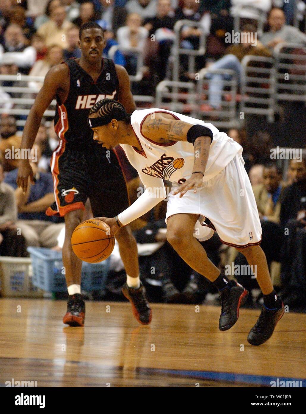 The Heats' Eddie Jones (6) watches as the 76ers' Allen Iverson (3) runs away with the ball as Philadelphia hosts Miami in the season opening game at the Wachovia Center in Philadelphia, on October 28, 2003. (JON ADAMS/UPI) Stock Photo