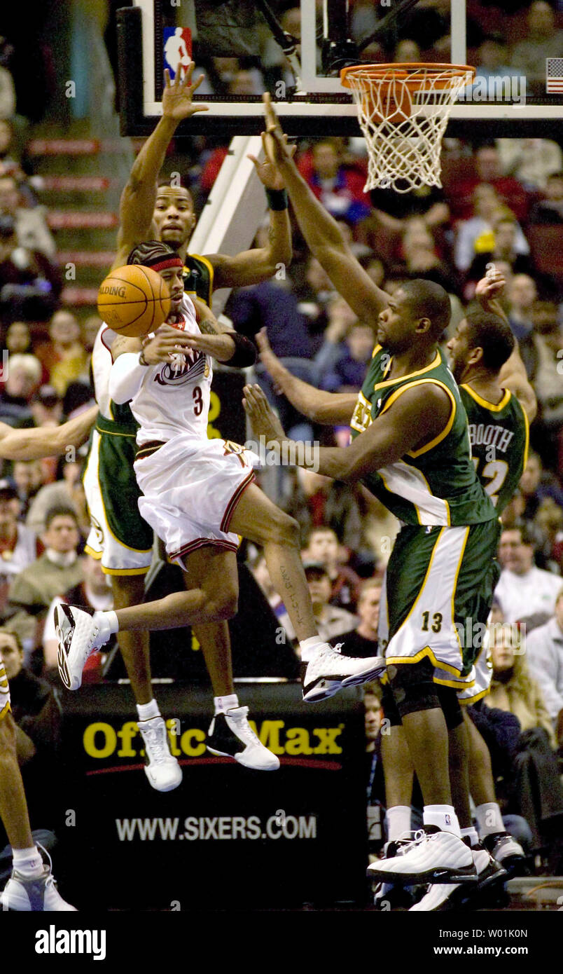 Seattle Supersonics center Jerome James, right, pulls the ball away from  Sacramento Kings guard Mike Bibby, center, as Kings' center Brad Miller,  left, falls to the floor during the first quarter of