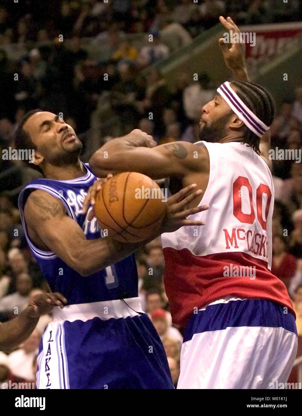 The Lakers' Maurice Carter (1) struggles for the rebound with the 76ers'  Amal McCaskill (00) as Philadelphia hosts Los Angeles in an evening game at  the Wachovia Center in Philadelphia, on February