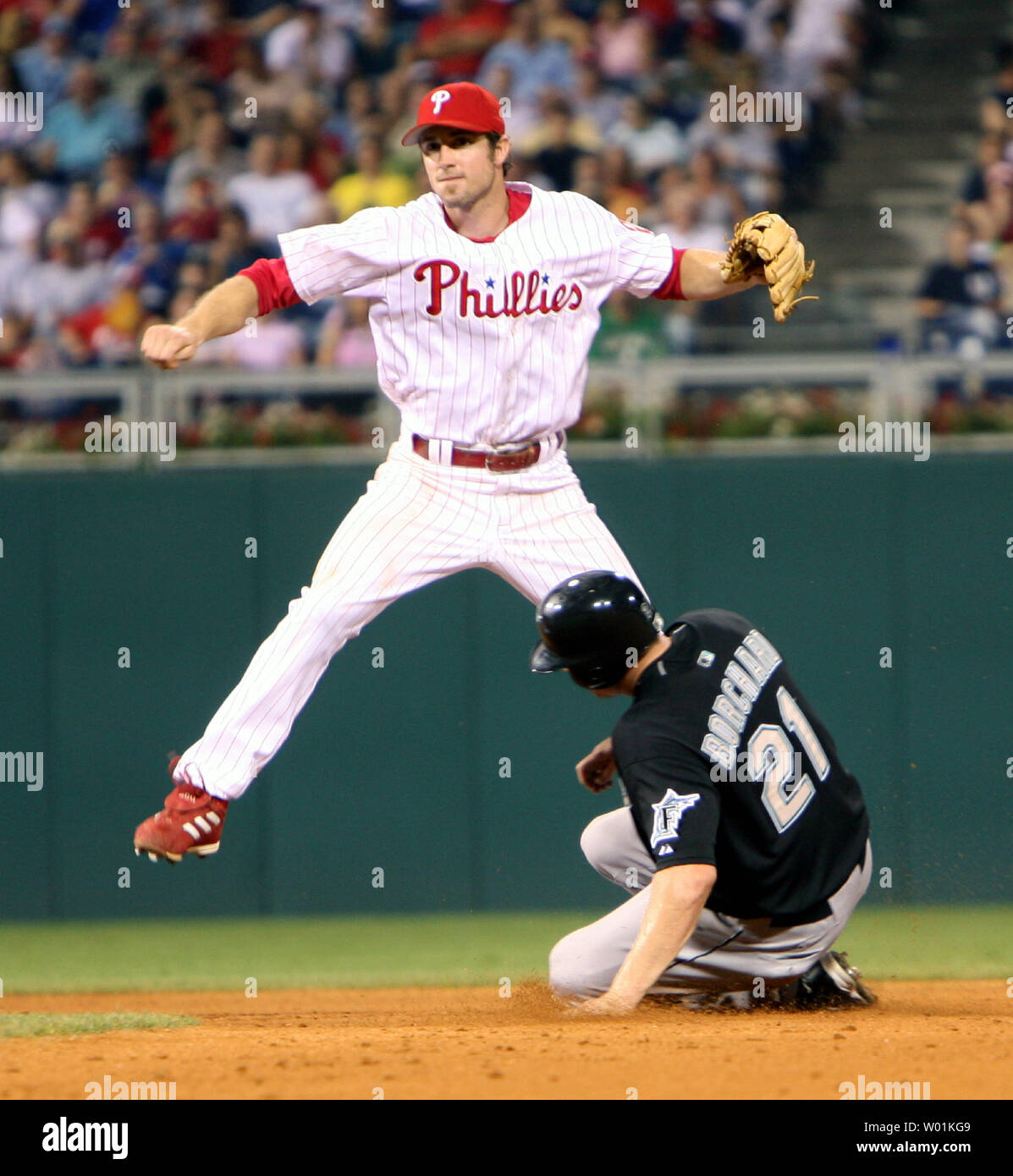 Philadelphia's second baseman Chase Utley goes high to avoid the