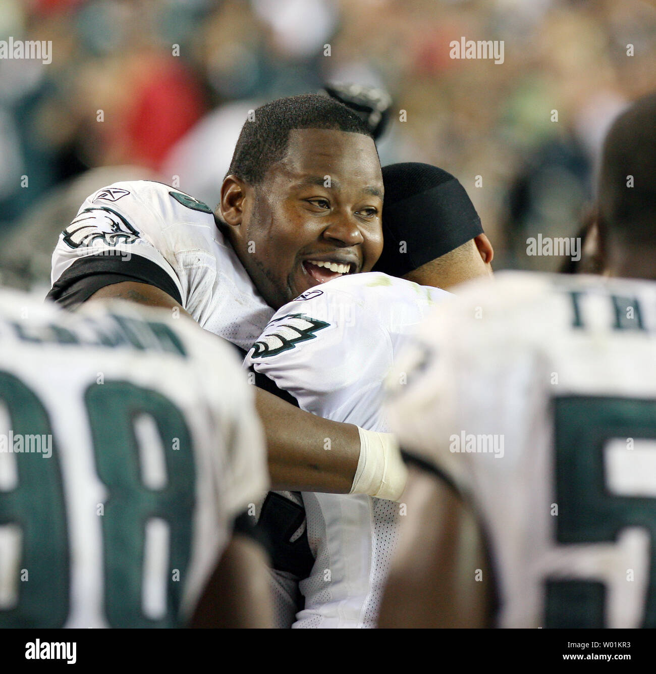 Philadelphia's Shawn Andrews hugs teammate Hank Baskett following an