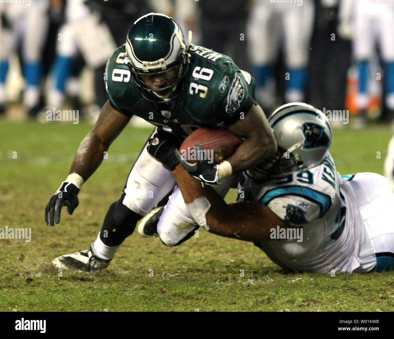 Philadelphia Eagles' running back Brian Westbrook (36) loses a yard as he tries to go through the middle and is dragged down on the Carolina seven yard line by Carolina Panthers Maake Kemoeatu (99) during the fourth quarter at Lincoln Field Philadelphia on December 4, 2006. Philadelphia defeated Carolina 27-24.   (UPI Photo/John Anderson) Stock Photo