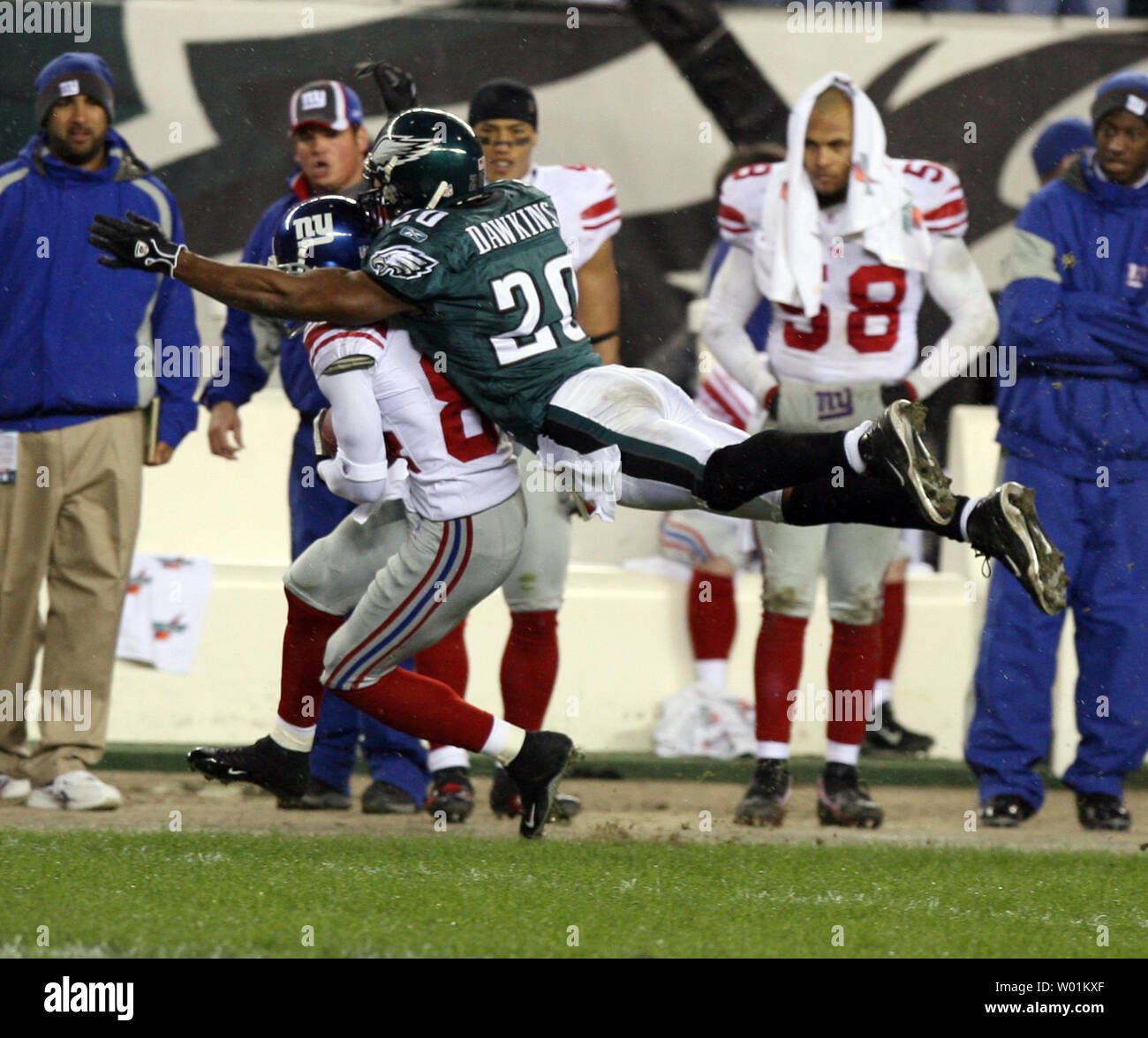 Philadelphia's Brian Dawkins (20) makes a flying tackle on New York Giants wide receiver Tim Carter on the Philadelphia 34-yard line during fourth quarter NFC Wildcard playoff action at Lincoln Financial Field in Philadelphia on January 7, 2006.    (UPI Photo/John Anderson) Stock Photo