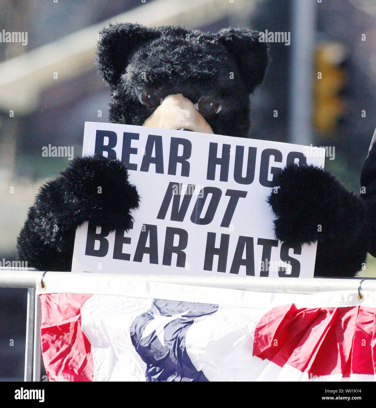 Dressed in a Bear costume, a protestor holds a sign calling for the British Royalty to stop using bear fur for the hats of their Royal Guard as Prince Charles arrives at Independence Hall January 27, 2007. The Prince and his wife the Duchess of Cornwall are on a 2-day visit to Philadelphia and New York.   (UPI Photo/John Anderson) Stock Photo