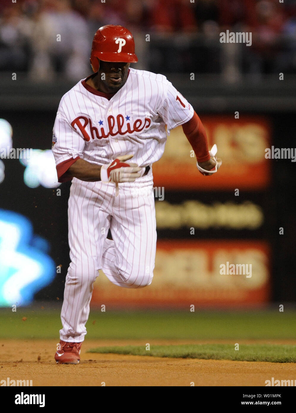 Philadelphia Phillies shortstop Jimmy Rollins runs to third base after  tagging up after Tampa Bay caught a pop-up during the first inning of game  4 of the World Series against at Citizens