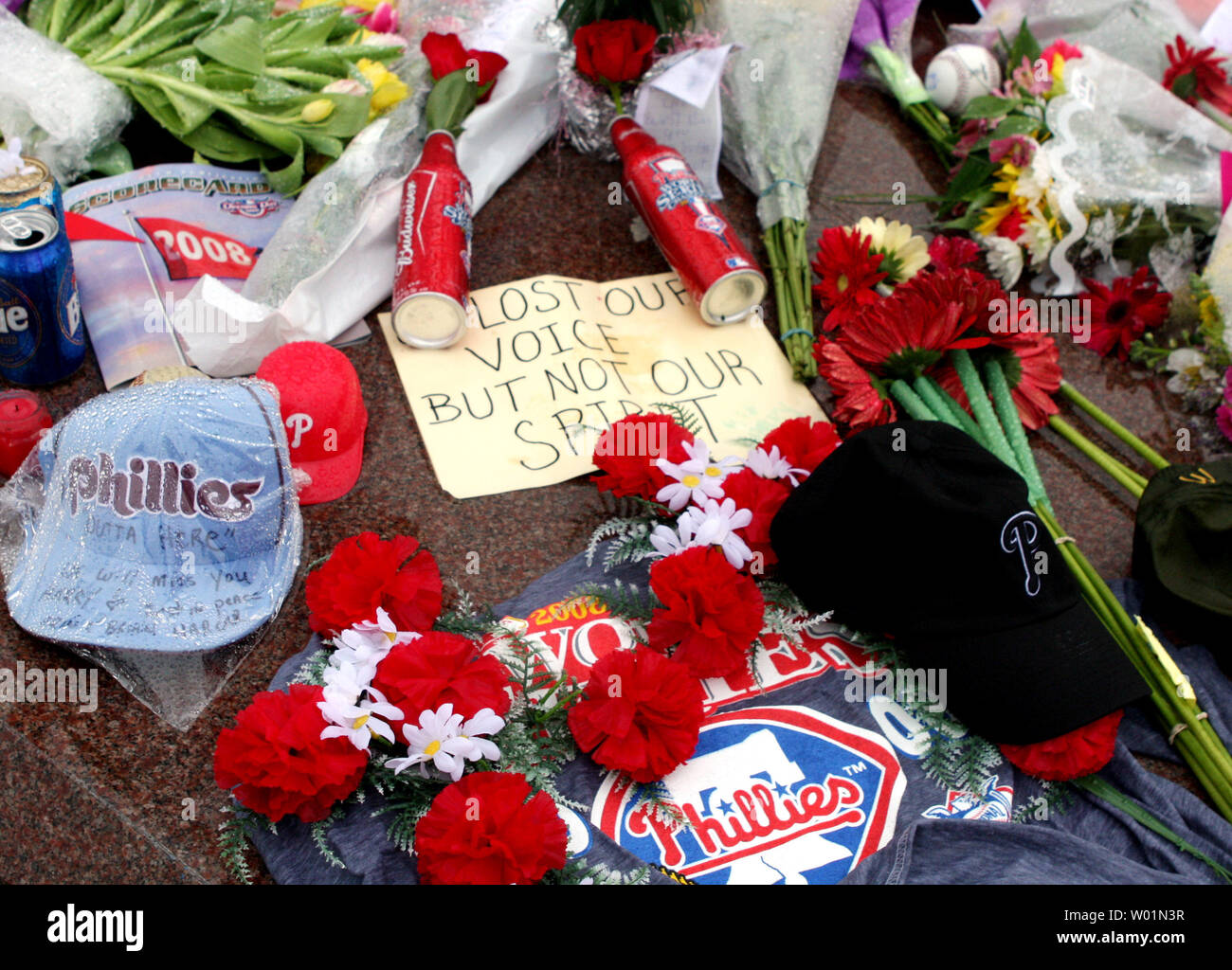 Flowers, notes of remembrance and jerseys are left at the base of a statue  of Philadelphia baseball player Mike Schmidt that has been tuned into a  memorial for longtime Philadelphia Phillies announcer