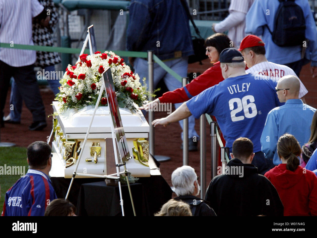 Some of the thousands of fans who came to Citizens Bank Park April 18, 2009 to pay their respects to longtime Hall of Fame Philadelphia Phillies announcer Harry Kalas reach over to touch the casket as it sits at home plate.  Kalas,  a Philadelphia Phillies announcer for the past 30 years, died earlier this week at a game.  He is only the second baseball person to lie in state in a professional baseball stadium since Babe Ruth in 1948.   (UPI Photo/John Anderson) Stock Photo