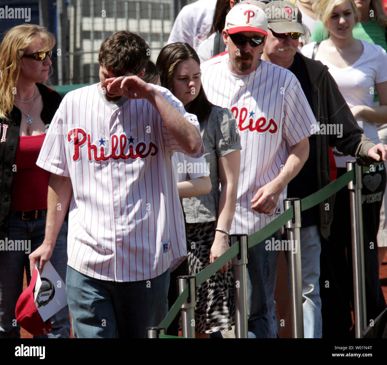 One of the manyf fans who came to Citizens Bank Park April 18, 2009 to pay their respects to longtime Hall of Famer Philadelphia Phillies announcer Harry Kalas fight by tears after passing by his casket..  Kalas,  a Philadelphia Phillies announcer for the past 30 years, died earlier this week at a game.  He is only the second baseball person to lie in state in a professional baseball stadium since Babe Ruth in 1948.   (UPI Photo/John Anderson) Stock Photo