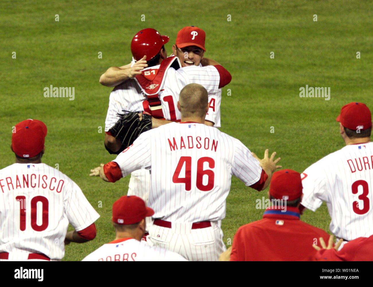 Philadelphia Phillies team members surge from the dugout and surround  closing pitcher Brad Lidge following their 10-4 win over the Los Angeles Dodgers in game five of the National League Championship Series in Philadelphia on October 21, 2009. Hugging Lidge is catcher Carlos Ruiz and running up to him are Ben Francisco, Ryan Madson and Rich Dubee (far right).      .      UPI/Eileen Angelino Stock Photo