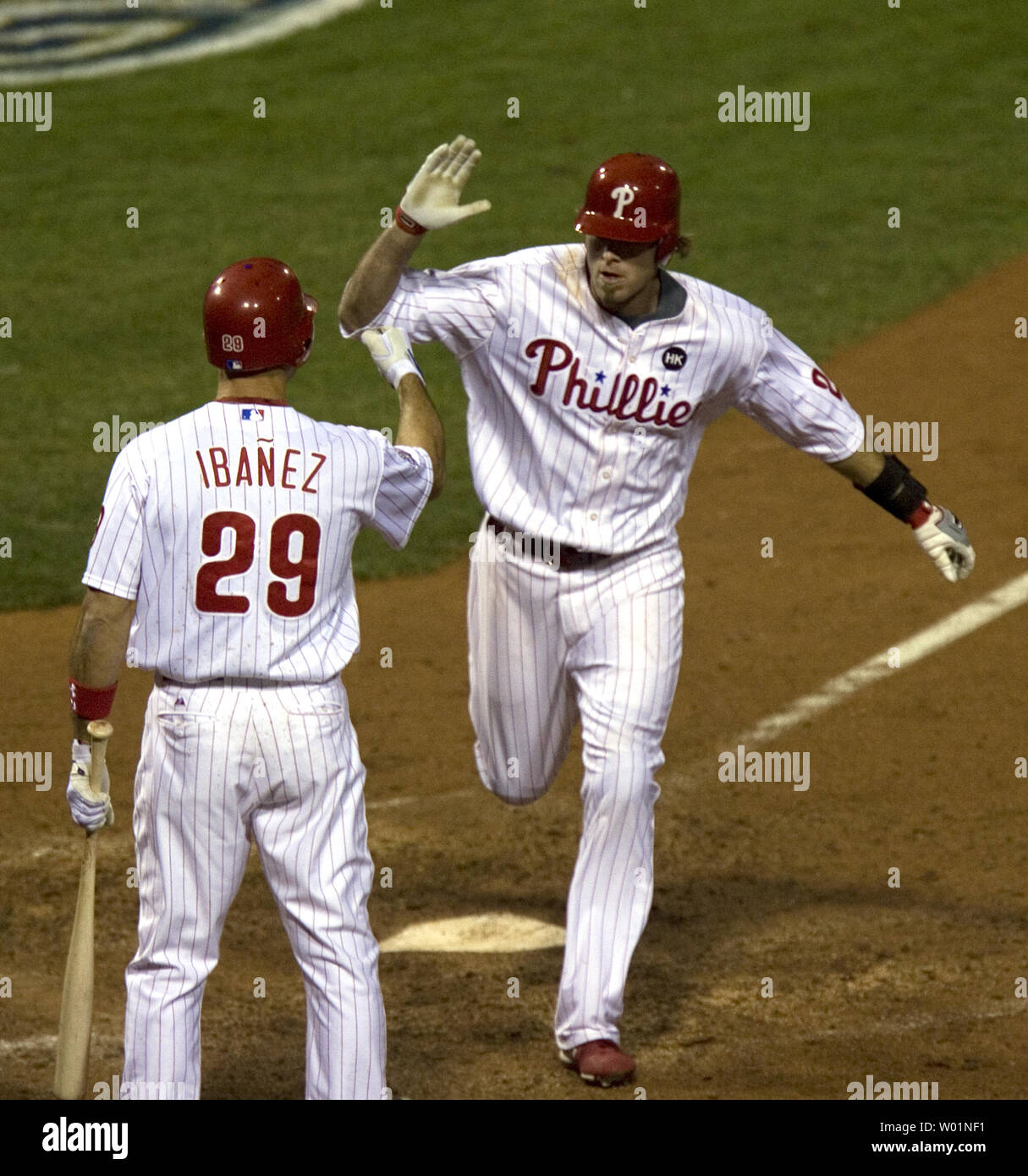 Philadelphia Phillies Jayson Werth high fives teammate Raul Ibanez as he crosses home plate after hitting a home run in the sixth inning of game 3 of World Series in Philadelphia on October 31, 2009.      UPI/John Anderson Stock Photo