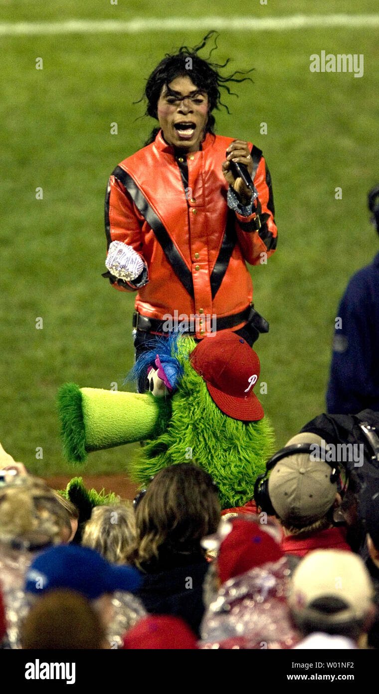 A Michael Jackson impersonator performs with the Phillie Phanatic atop the Philadelphia Phillies dugout during the 7th inning stretch of game 3 of World Series in Philadelphia on Halloween night October 31, 2009. New York defeated Philadelphia 8-5.      UPI/John Anderson Stock Photo