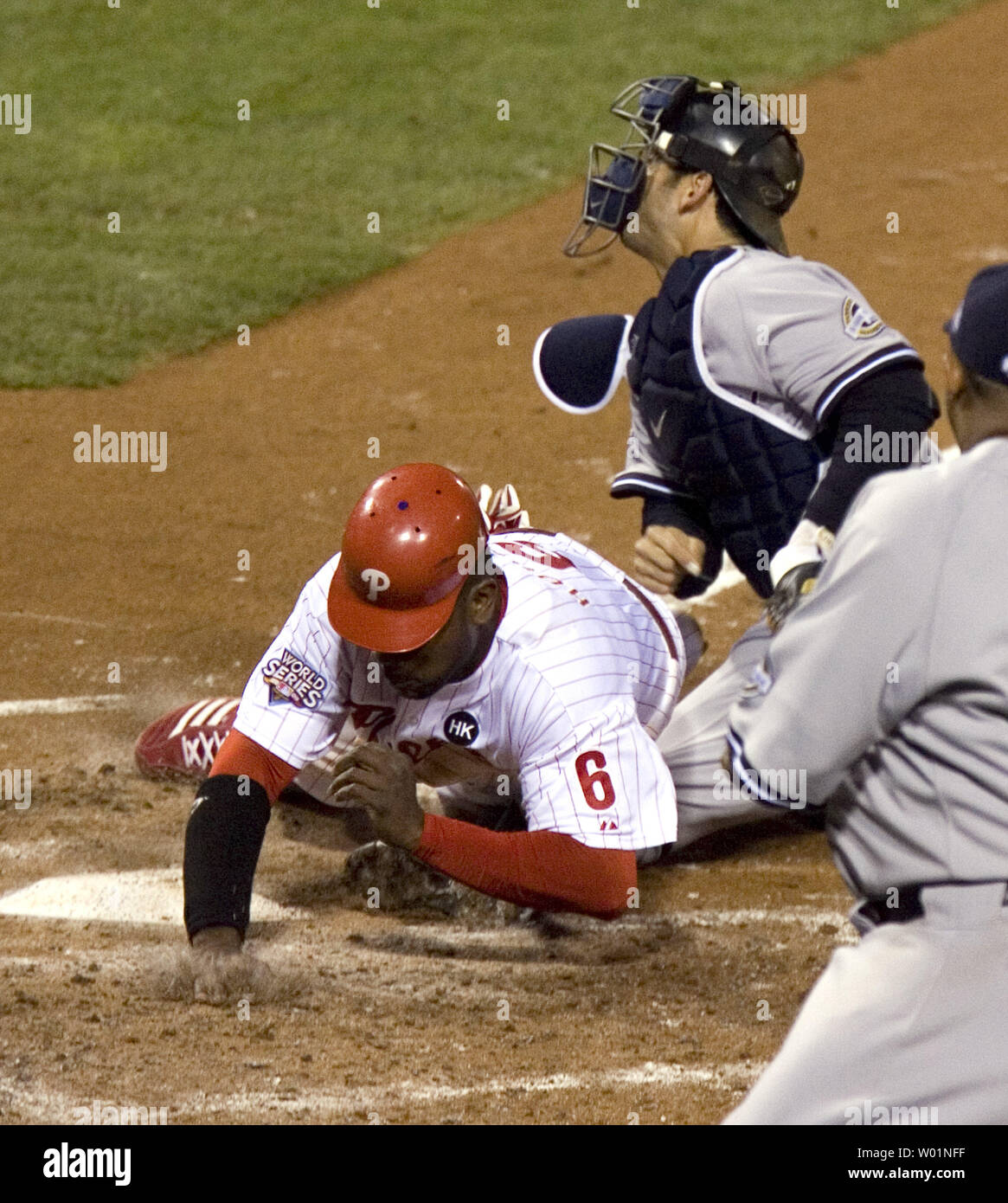 Philadelphia Phillies Ryan Howard safely slides into home during the fourth inning of game 4 of the World Series in Philadelphia on November 1, 2009. Catching for the New York Yankees is Jorge Posada.     UPI/John Anderson Stock Photo