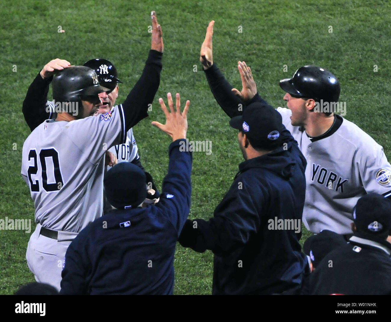 New York Yankees catcher Jorge Posada (R) is congratulated after