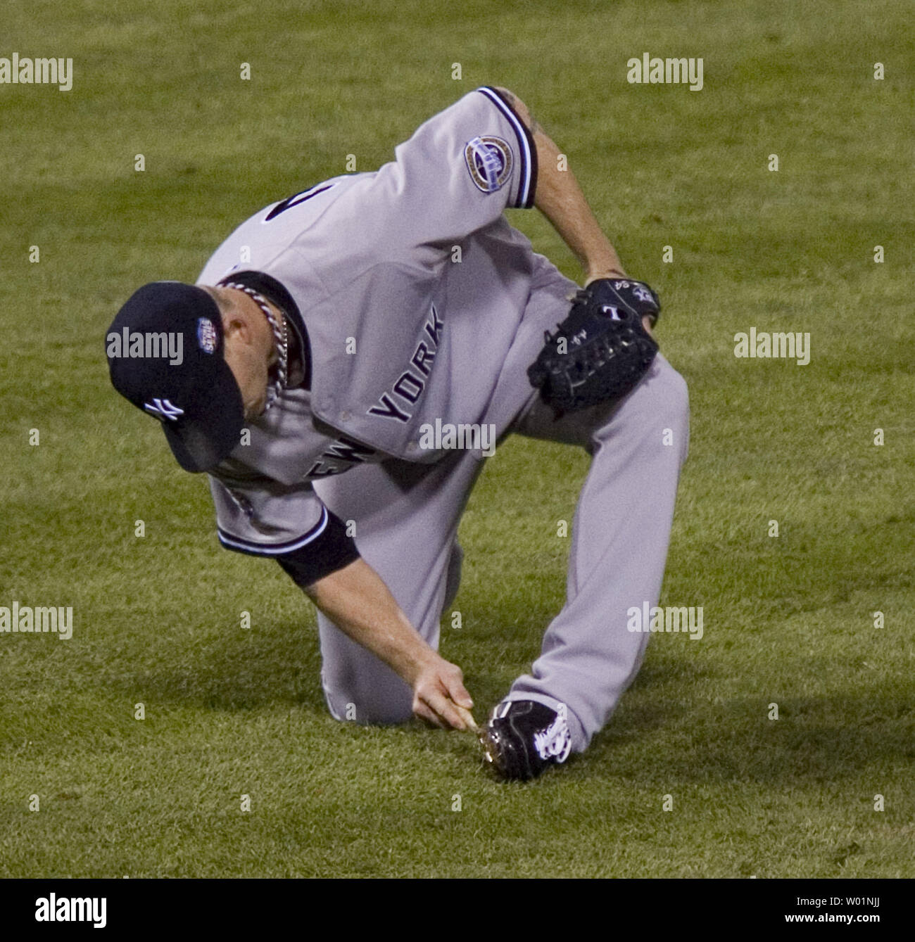 New York Yankees pitcher A. J. Burnett stops the game during first inning of game 5 of the World Series in Philadelphia on November 2, 2009 to clean mud off his cleats.      UPI/John Anderson Stock Photo