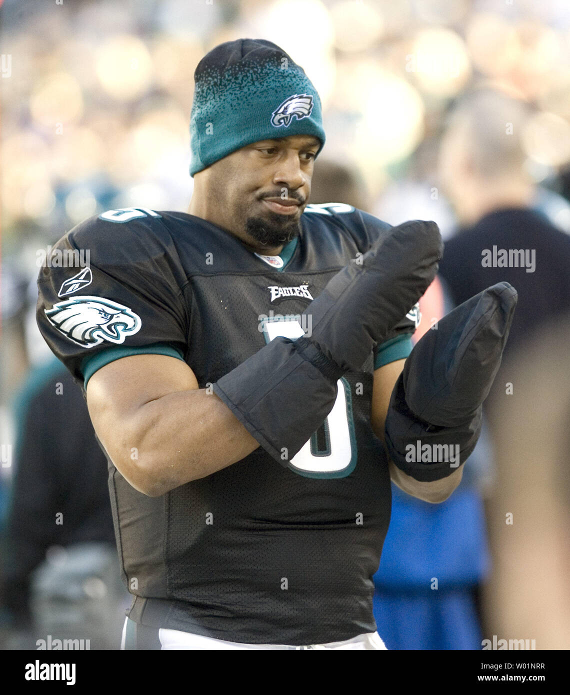 Philadelphia Eagles quarterback Donovan McNabb adjusts his wool cap while  wearing heavy gloves as he tries to keep warm on the sidelines during  second quarter against the Buffalo Bills in Philadelphia at