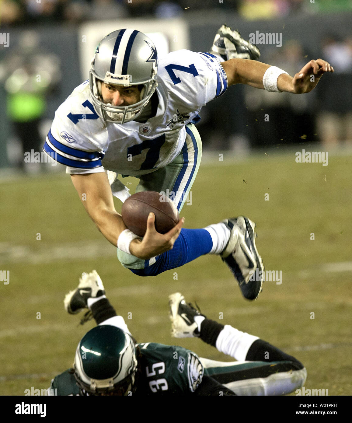 Dallas Cowboys quarterback Stephen McGee sails through the air over Philadelphia Eagles cornerback Trevard Lindley after Lindley tripped him up trying to tackle him in fourth quarter Philadelphia Eagles-Dallas Cowboys game action in Philadelphia at Lincoln Financial Field January 2, 2011. McGee gained 14-yards on the play.      UPI/John Anderson Stock Photo
