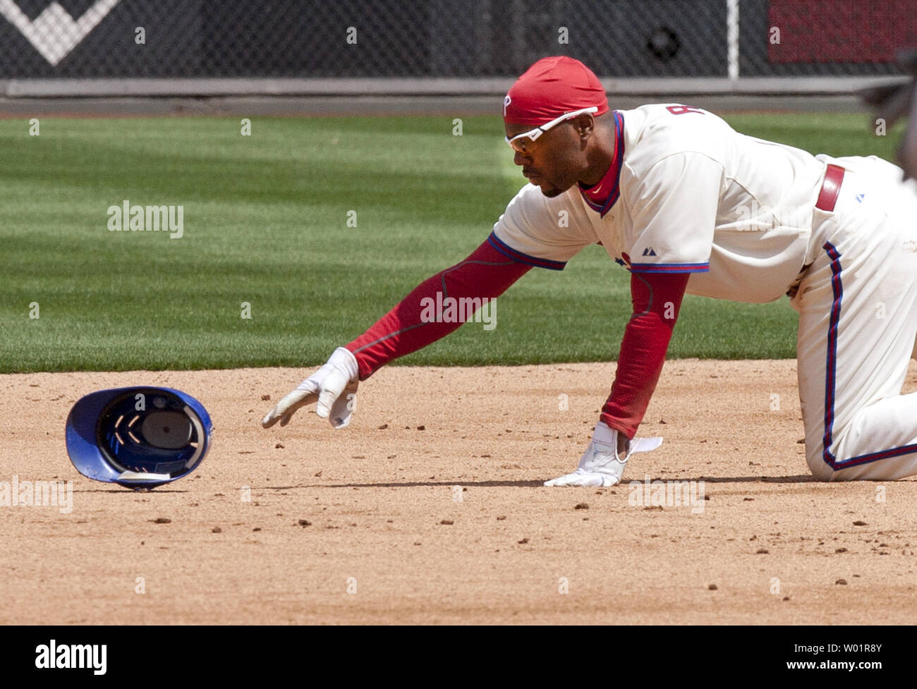 Philadelphia Phillies  Jimmy Rollins chases after his helmet after loosing it when he dove back to 2nd base in the first inning against the Miami Marlins at Citizens Bank Park in Philadelphia 4/9/2012.   UPI/John Anderson Stock Photo