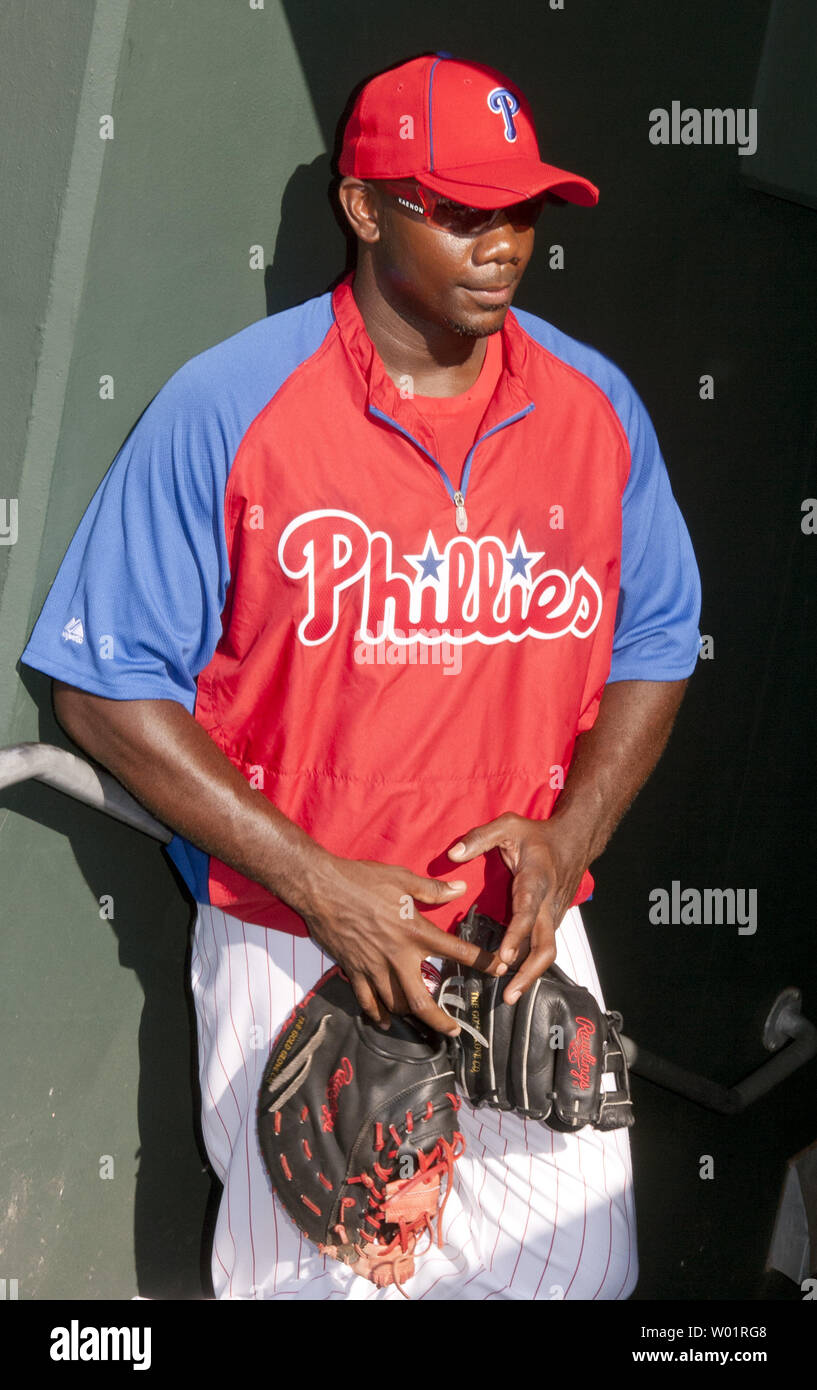 Philadelphia Phillies star first baseman Ryan Howard, who has been out injured all season, carries two first base gloves as he comes out of the dugout prior to the Atlanta Braves-Philadelphia Phillies game July 6, 2012. The former NL MVP has been sidelined the entire season after rupturing his left Achilles tendon while making the final out in Philadelphia's loss to St. Louis in Game 5 of the NL division series last October.   UPI/John Anderson Stock Photo