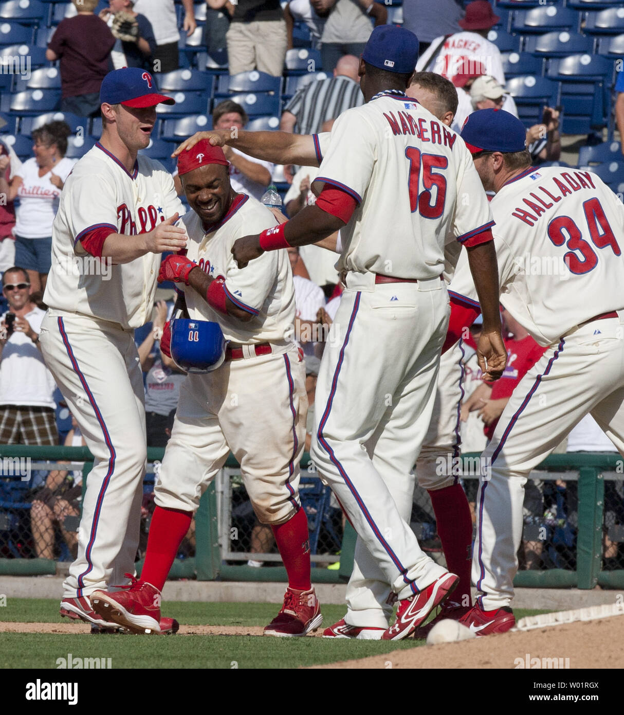 Philadelphia Phillies teammates congratulate Jimmy Rollins after he hit an RBI in the 12th inning against the San Francisco Giants at Citizens Bank Park in Philadelphia on July 22, 2012 winning the game 4-3. UPI/John Anderson Stock Photo
