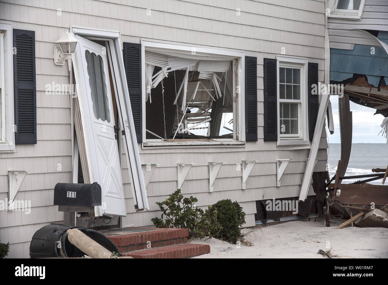 Windows are blown out, doors torn out of their frames and the ocean can be seen through holes in this beach front  house on Long Beach Island November 1, 2012. Many homes on this resort New Jersey island were destroyed and tons of sand covers everything after Hurricane Sandy hit the area late October 29, 2012.                     UPI/John Anderson Stock Photo