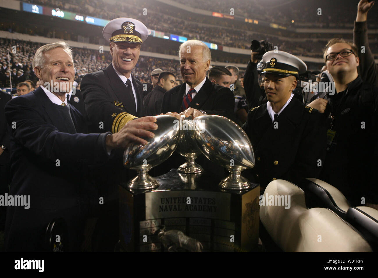 Secretary of Navy Ray Mabus (far L), Michael Miller, Superintendent of the  U.S. Naval Academy, Vice-President Joe Biden and a unidentified Navy  midshipman stand with the Commander in Chief trophy at the