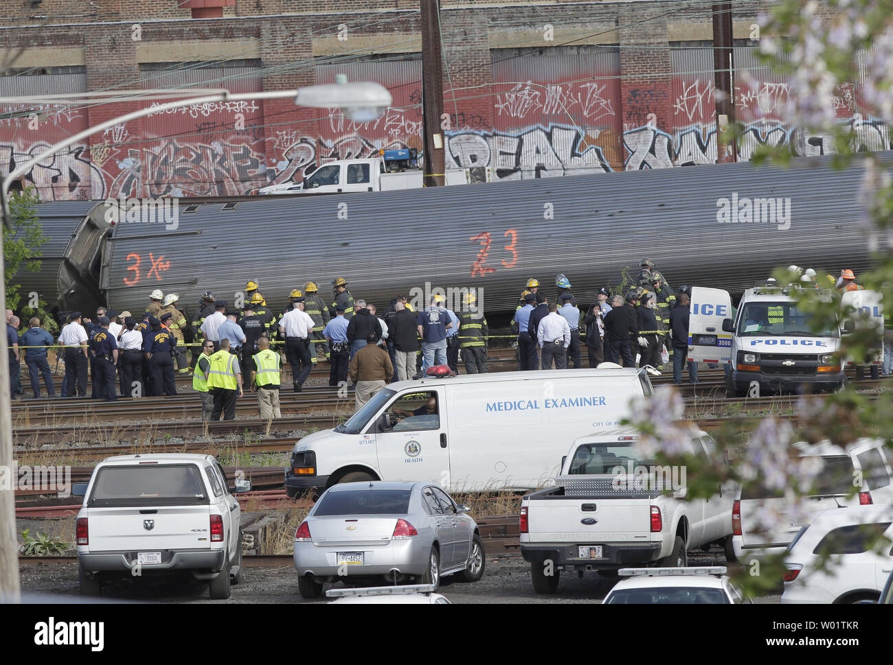 A Medical Examiner truck pulls up to where Police, emergency and rescue  workers surround the car of an Amtrak train that crashed on May 13, 2015 in  Philadelphia. At least six people