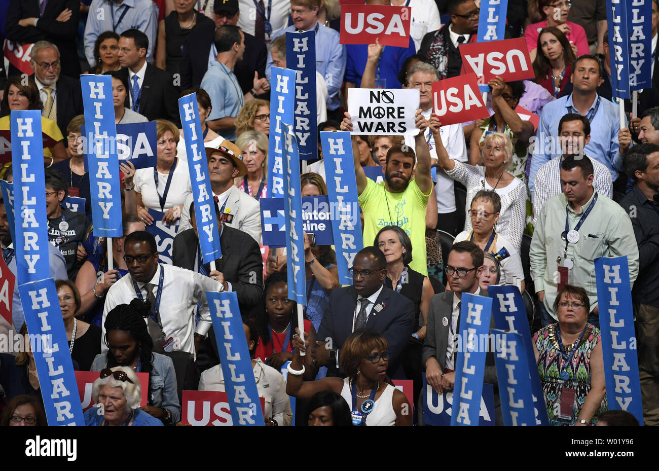 A lone Bernie Sanders supporter holds a 'No More War' sign (C) as he is surrounded by Hillary Clinton supporters, during Day four of the Democratic National Convention at Wells Fargo Center in Philadelphia, Pennsylvania on July 28, 2016.  Democrat Hillary Clinton will face Republican Donald Trump in the national election.   Photo by Mike Theiler/UPI Stock Photo