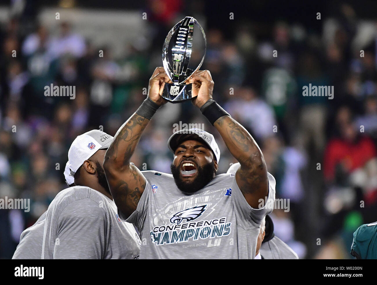 Philadelphia Eagles defensive end Vinny Curry (75) celebrates with the  George Halas NFC Championship Trophy after the Eagles defeated the  Minnesota Vikings 38-7 to win the NFC Championship at Lincoln Financial  Field