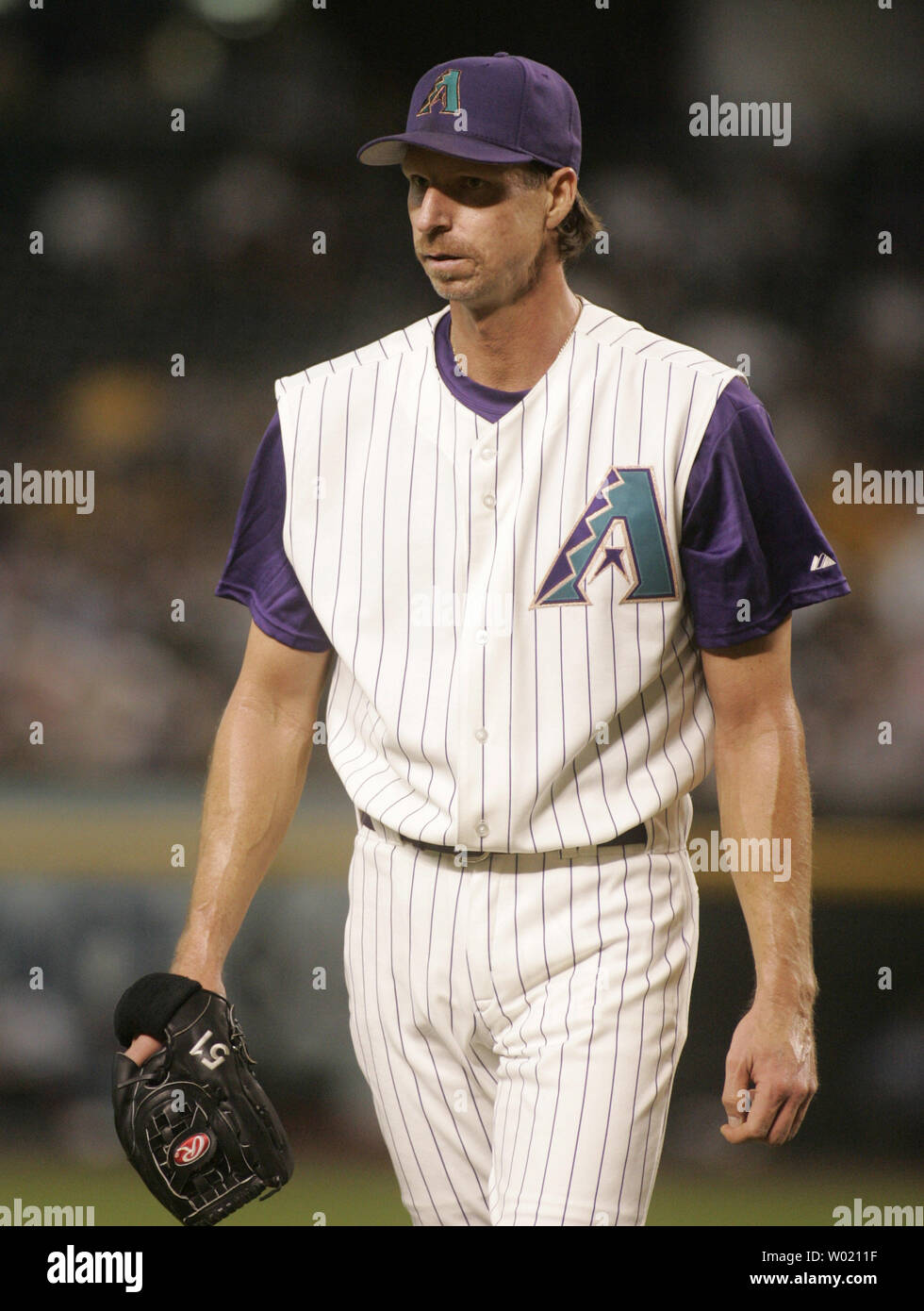 Arizona Diamondbacks starting pitcher Randy Johnson walks back to